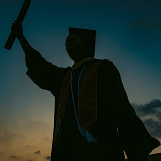 Graduate holding up diploma