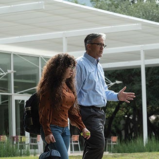 student walking with faculty