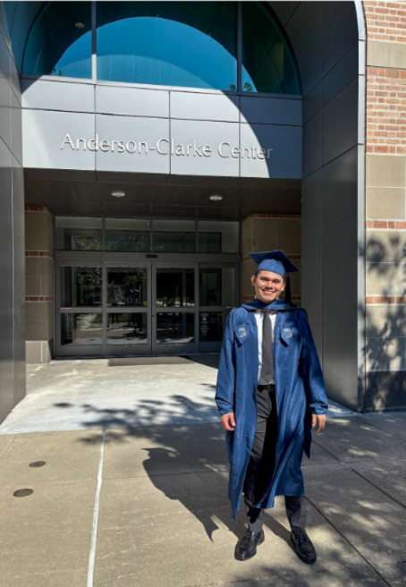 male college student wearing his gap and gown